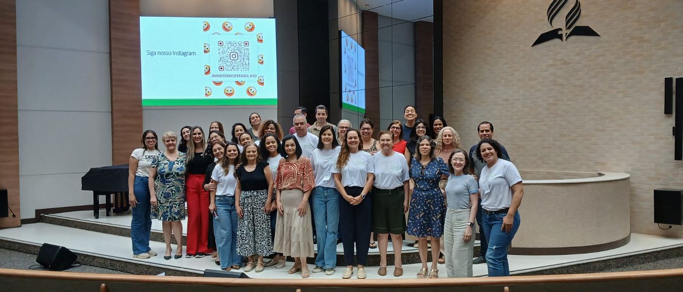 Grupo grande reunido no auditório da igreja ao final de um encontro